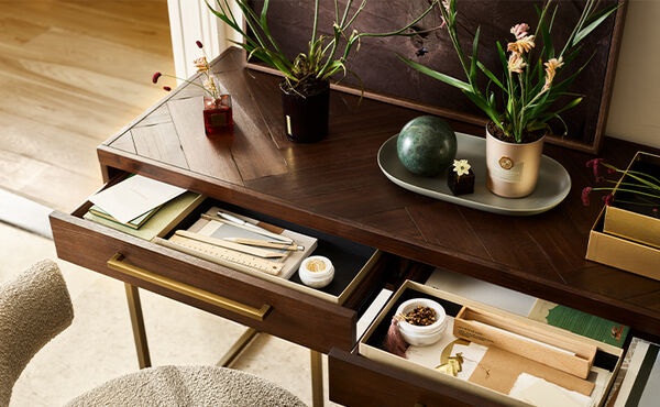 Rituals gift boxes reused as drawer organisers in a home office.